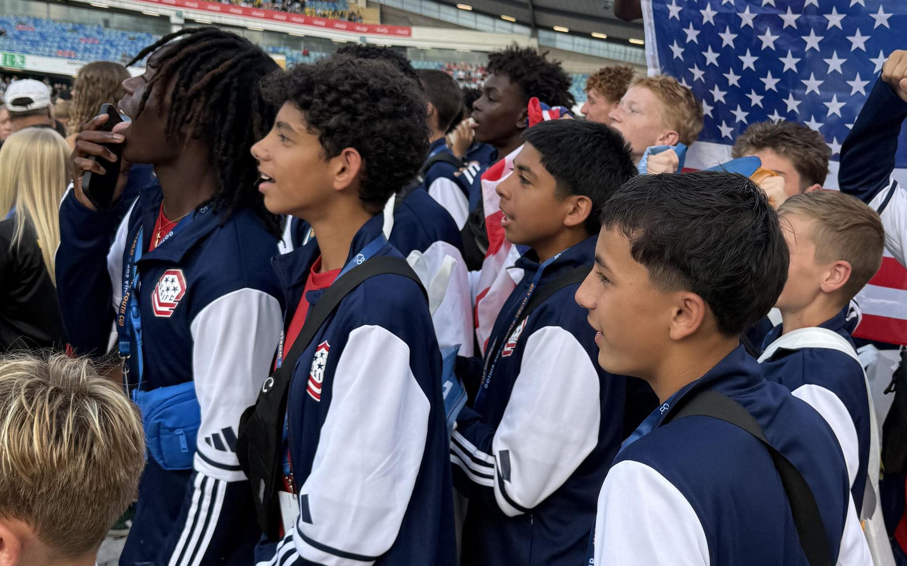USIFC players in tracksuits look out across Ullevi Stadium during the opening ceremony